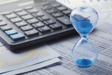 Best time for investment. Hourglass, financial charts and calculator.