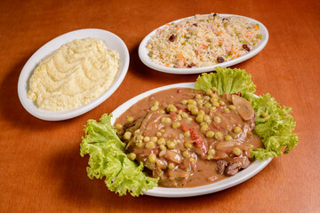 Fillet mignon with wood sauce, accompanied by Greek rice and mashed potatoes. Popular dish in Brazil