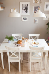 Festive table in a bright living room with fragrant homemade bread
