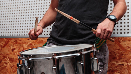 Close-up of drumsticks being played on a drum