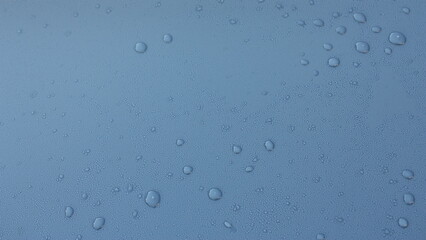 Real hydrophobic effect with melting drops of frost on a modern gray car body (Kemora gray metallic effect) treated with wax