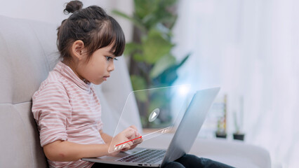 Asian little girl using the laptop. Internet of Things. EdTech.