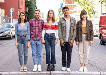 Urban group of young university students standing on city street - New normal social life concept with young citizens worried about the problems of society and the world - Casual trendy clothing - obrazy, fototapety, plakaty