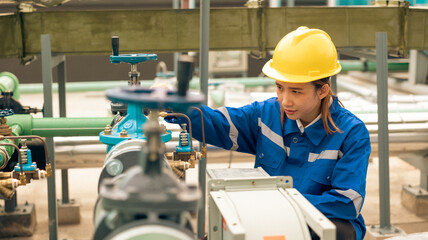 Portrait confident professional engineer woman wearing safety uniform and hard hat helmet in industrial factory workplace rooftop