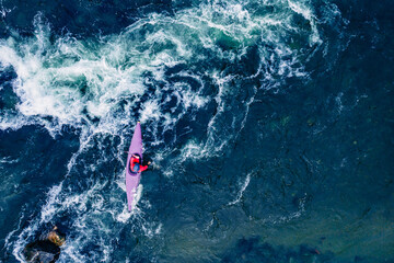 Top view boat of kayaker on mountain rough river, extreme sport kayak, aerial drone photo