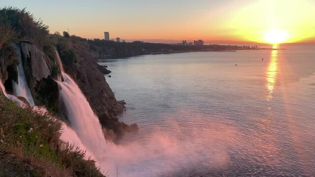 Duden waterfall in the Duden park on the Mediterranean coast in Antalya, Turkey. View of  seascape, beautiful sea and steep rock on a sunrise