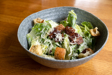 Caesar salad in a bowl on the table