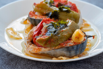 Delicious traditional Turkish fish dish, Palamut Pilaki. Presentation of a great fish dish on a white plate. top shot.