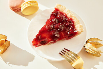 Aesthetic fall cherry pie, macaroons, winter cherry under hard shadows. Hygge atmosphere. Minimalist background