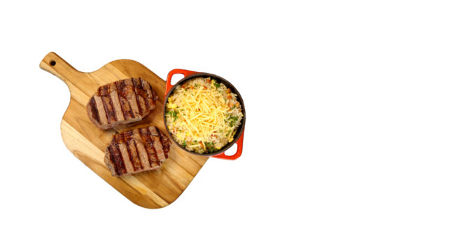 Delicious juicy Ancho steak with grill marks and accompaniment of farofa on the side. Brazilian food. Top view