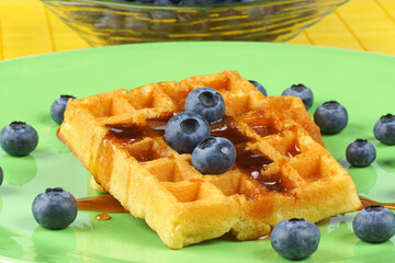 Waffles with syrup and fresh blueberries