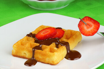 Waffle with chocolate sauce and strawberry