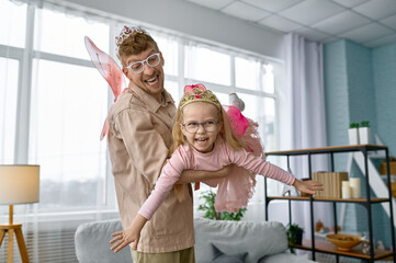 Father and daughter wearing fairies costume having fun