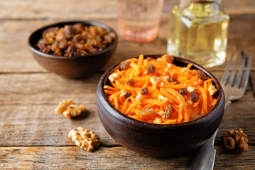 Carrot walnut raisin salad with glass of water