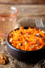 Carrot walnut raisin salad with glass of water