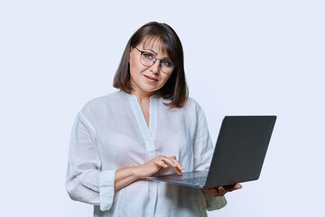Smiling woman with laptop on white background