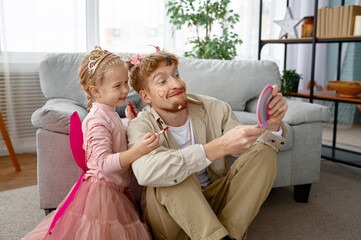Little happy daughter and father with funny makeup