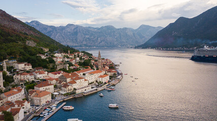 Fototapeta na wymiar Perast city is the most beautiful place in Kotor Bay in Montenegro. Wonderful architecture and history with old church and nice view on clear sea. Romantic place for summer vacation or honeymoon. 