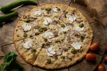 Tasty pizza with onions, and mushrooms on a wooden background
