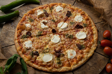 Traditional italian food. Delicious fresh pizza with cheese,  and onion on wooden background with ingredients, flat lay.