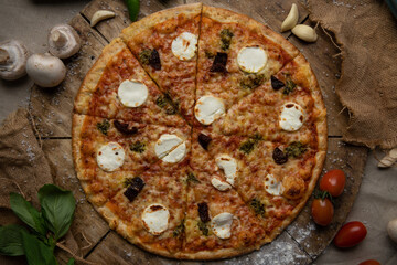 Traditional italian food. Delicious fresh pizza with cheese,  and onion on wooden background with ingredients, flat lay.