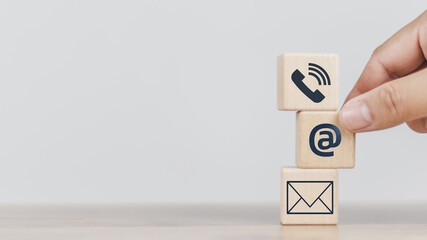 Customer support hotline Contact us concept cube wood showing icons, smartphones, message boxes, addresses and letters, conveys the contact channel. with the service online support for advice