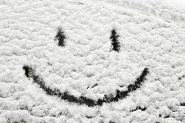 Winter decoration. Smiley face on a snowy car window. Hearty congratulations on the winter holidays. Creating a good mood. Background. - 543248564