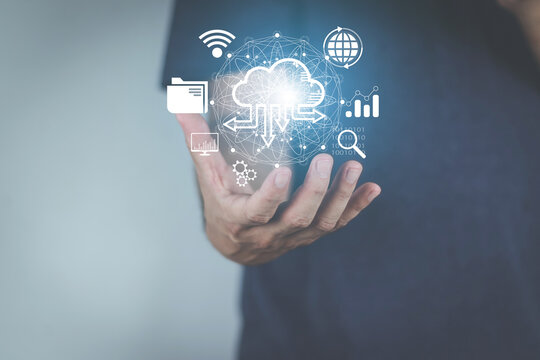 cloud computing concept man's hand holding a virtual image cloud storage which is a form of digital computer data storage That helps facilitate both small and large organizations as well