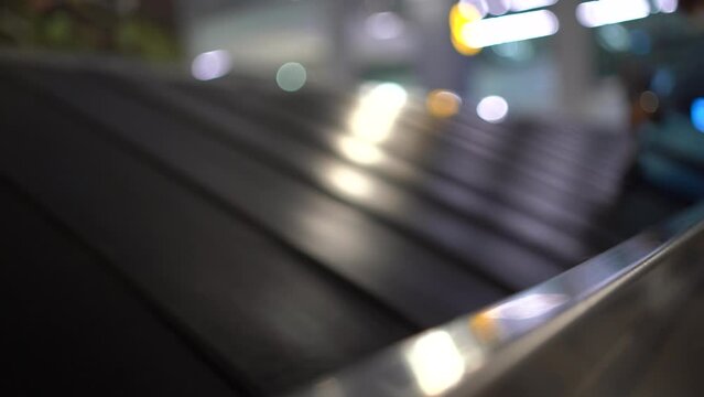 Various suitcases moving on the luggage conveyor belt at arrival area in the passenger terminal at Soekarno Hatta International airport