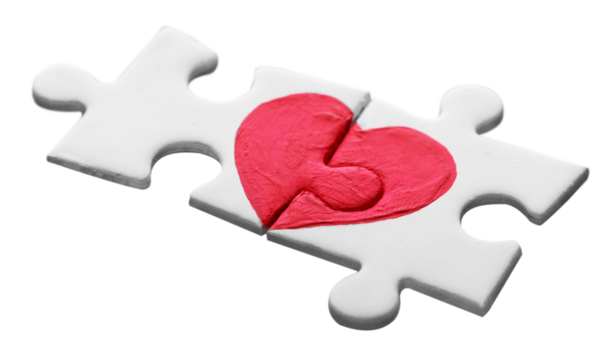 Puzzle pieces with painted red heart on it, white background