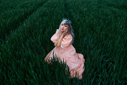 Girl in a dress in a yellow-green field