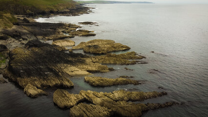 Fototapeta na wymiar Rocks in seawater, top view. Geological formations on the Atlantic Ocean coast. Drone point of view.