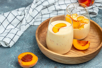 Peach drink in a glass with milk on a light background, Healthy eating. Breakfast, snack, Restaurant menu, dieting, cookbook recipe top view