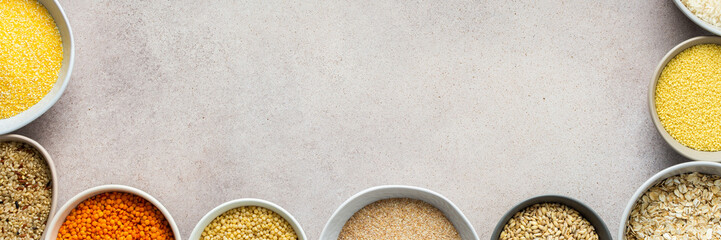 Various grain cereals in bowls banner, top view