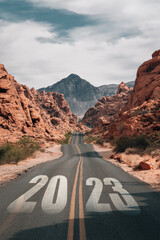 road to 2023. the road leads to red mountains in the desert of nevada USA.