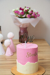 pink caps, a cake and a bouquet of flowers