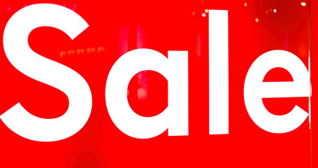 Big sign on red background with white SALE words at entrance