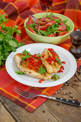 Roasted chicken meat served on wooden table