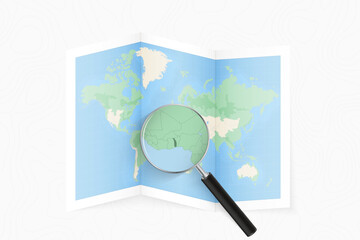 Enlarge Togo with a magnifying glass on a folded map of the world.