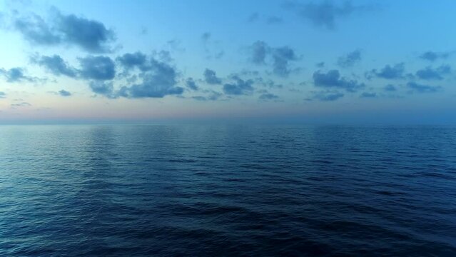Dark blue calm sea at sunset. Open sea or ocean in the evening, aerial view