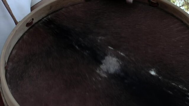 Man Playing a Typical "Bombo Leg&uuml;ero", a Bass Drum made with Wood and Animal Leather in Argentina. Close Up.  