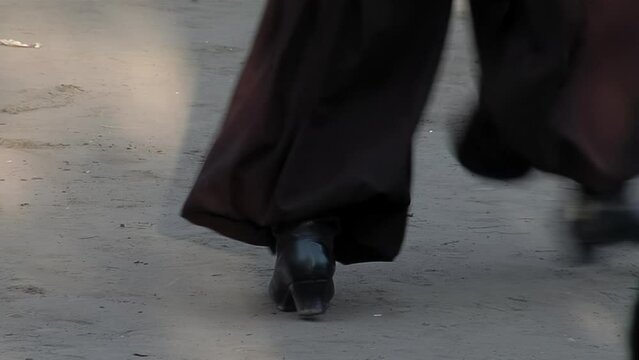 A Gaucho Stomping His Leather Boots while Dancing "Zapateo", an Argentine Folklore Dance originated in Santiago del Estero province, Argentina. Low Angle View.  