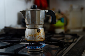 A coffee moka is seen on top of a kitchen stove with a blue gas flame. Due to Russia's invasion of...