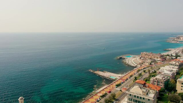Scenic Drone View of Coast of Ligurian Bogliasco town in Summer in Genoa, Italy, Europe. Panoramic Scene of Mediterranean city and Road traffic. Urban tourism, Boccadasse and Travel. 4k drone shot