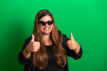 Young woman, wearing black glasses on   Green Background