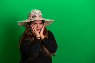 Young woman wearing a hat,   Green Background