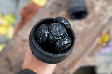 Auto mechanic holding CV axle joint.