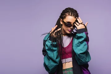 Fotobehang Kapsalon Young woman with braids hairstyle and retro clothes looking at camera isolated on purple.  © LIGHTFIELD STUDIOS