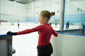 A little girl goes out to the skating rink for a lesson.