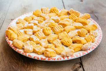 Plate with home made carrot gnocchi, ready to be cooked.